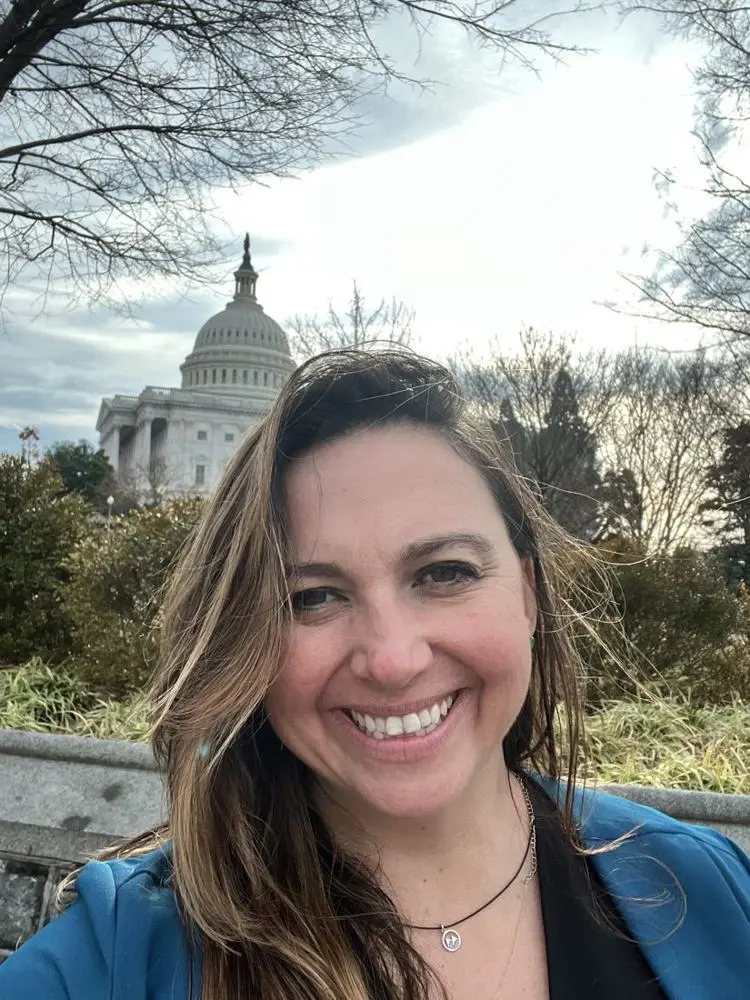 Val smiling in front of the U.S. Capitol