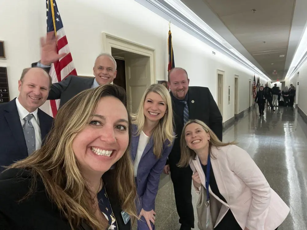 Val with fellow local leaders in a hallway on Capitol Hill